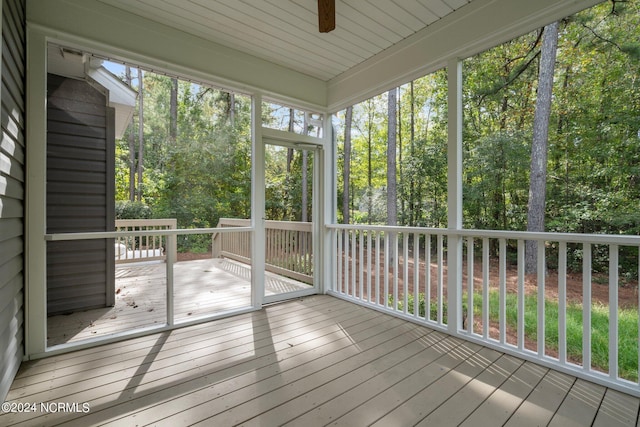 unfurnished sunroom featuring ceiling fan