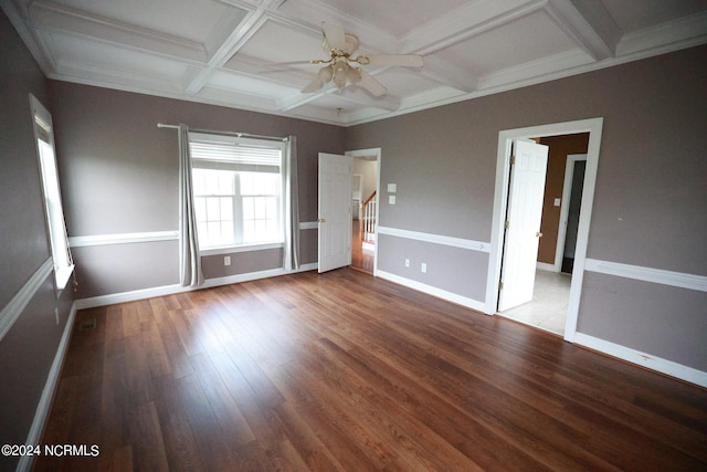 unfurnished bedroom with ceiling fan, beamed ceiling, dark wood-type flooring, coffered ceiling, and crown molding