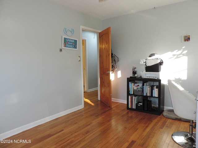 home office with hardwood / wood-style floors