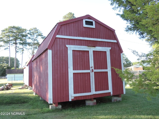 view of outbuilding with a lawn