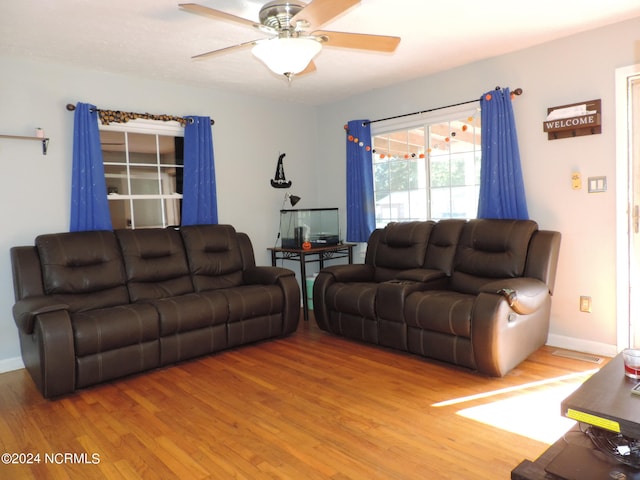 living room featuring hardwood / wood-style floors and ceiling fan