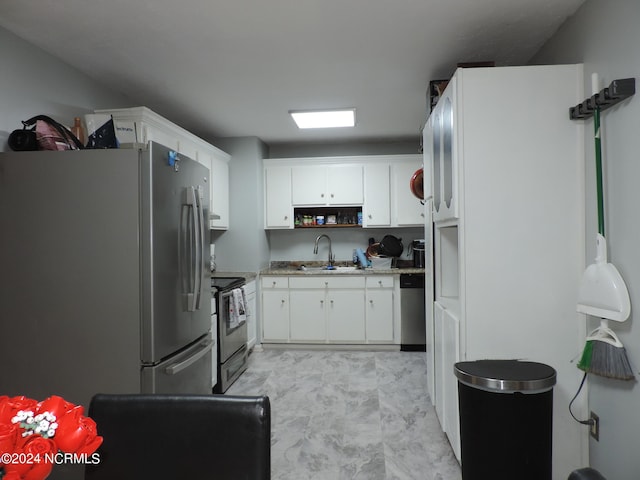 kitchen featuring sink, stainless steel appliances, and white cabinets