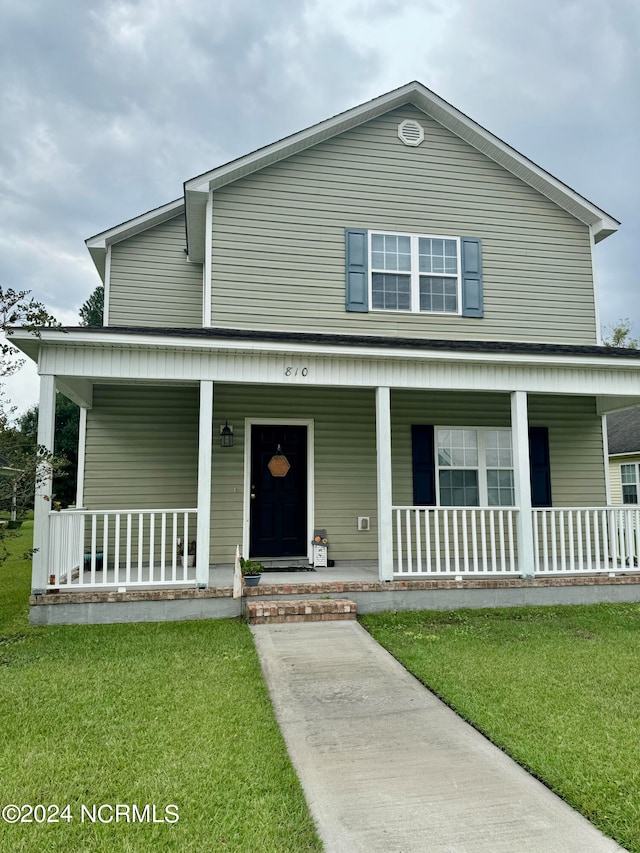 view of front of property with a front lawn and covered porch