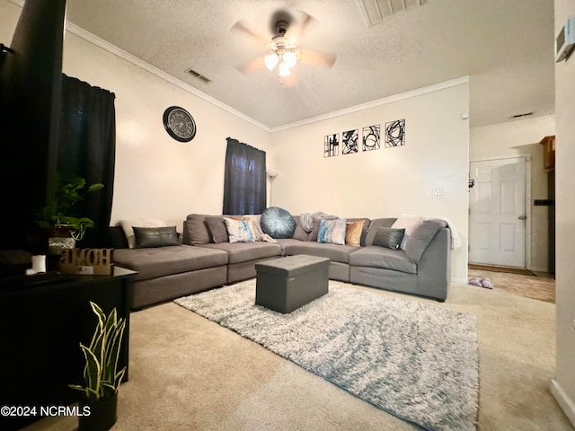 living room with ceiling fan, a textured ceiling, crown molding, and carpet