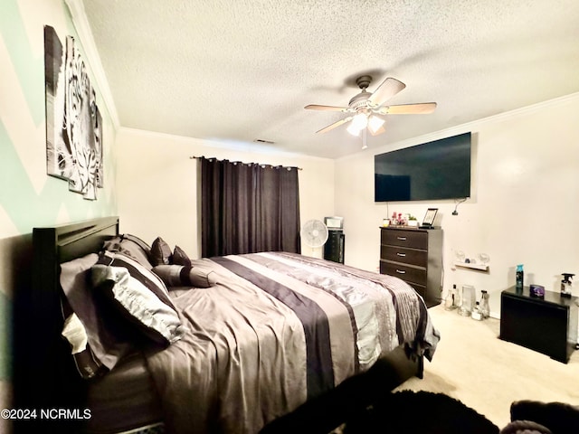 bedroom with a textured ceiling, crown molding, carpet flooring, and ceiling fan