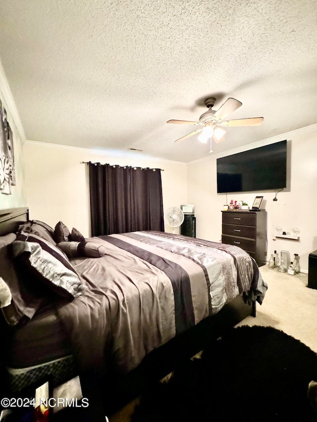 bedroom featuring crown molding, ceiling fan, carpet floors, and a textured ceiling