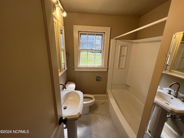 full bath with toilet, a sink, marble finish floor, shower / washtub combination, and baseboards