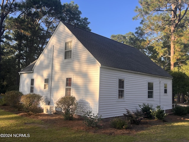 view of side of property featuring roof with shingles