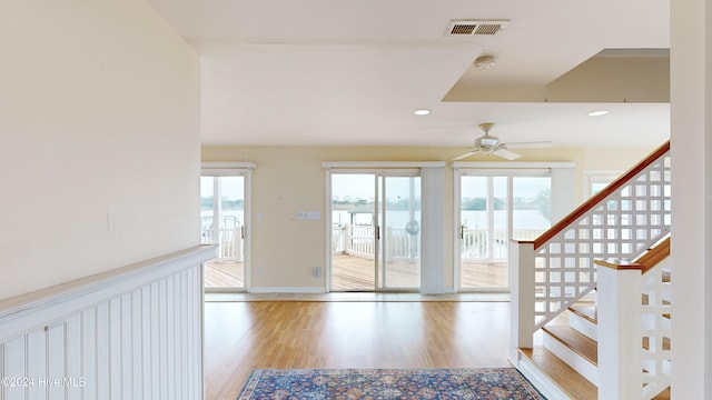 entryway with ceiling fan, a healthy amount of sunlight, and light hardwood / wood-style floors