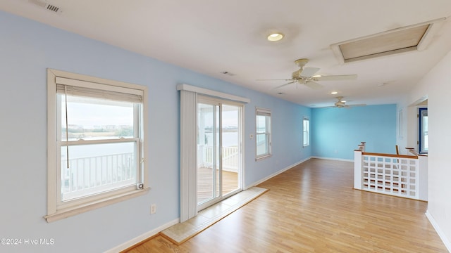 spare room featuring ceiling fan and light hardwood / wood-style flooring