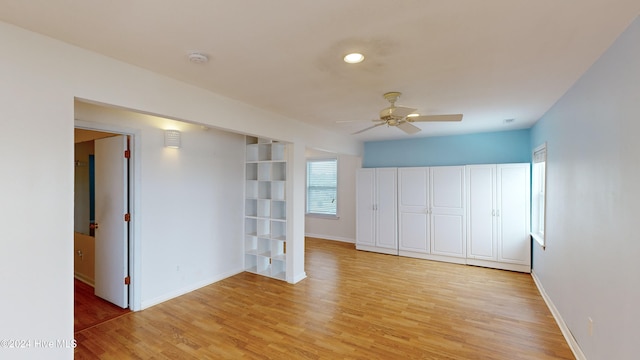 spare room featuring ceiling fan and light hardwood / wood-style floors