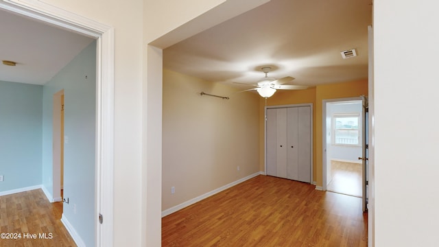 spare room with ceiling fan and light wood-type flooring