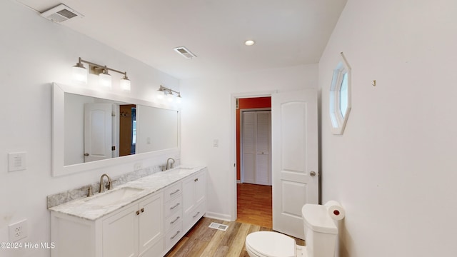 bathroom featuring hardwood / wood-style flooring, vanity, and toilet