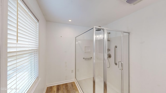 bathroom featuring hardwood / wood-style floors and walk in shower