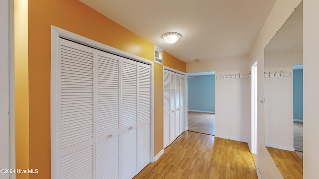 corridor with light hardwood / wood-style floors