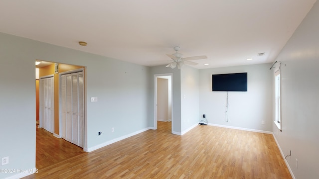 unfurnished room with ceiling fan and light hardwood / wood-style flooring