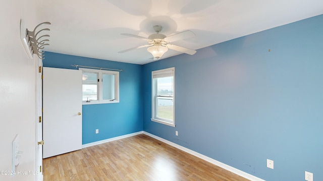 empty room with light hardwood / wood-style flooring and ceiling fan