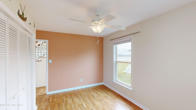 unfurnished room featuring ceiling fan and light wood-type flooring