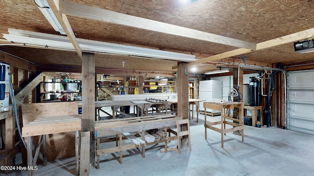 garage featuring a workshop area and white fridge