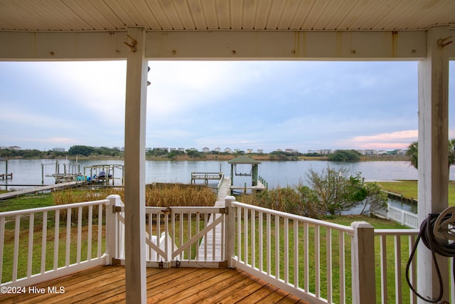 wooden terrace with a boat dock and a water view