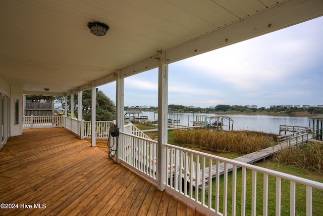 wooden terrace featuring a water view