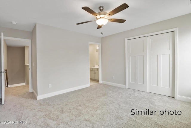 unfurnished bedroom featuring light colored carpet, a closet, and ceiling fan