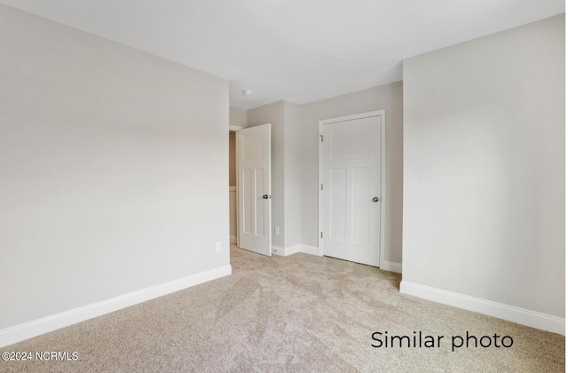 empty room with light colored carpet