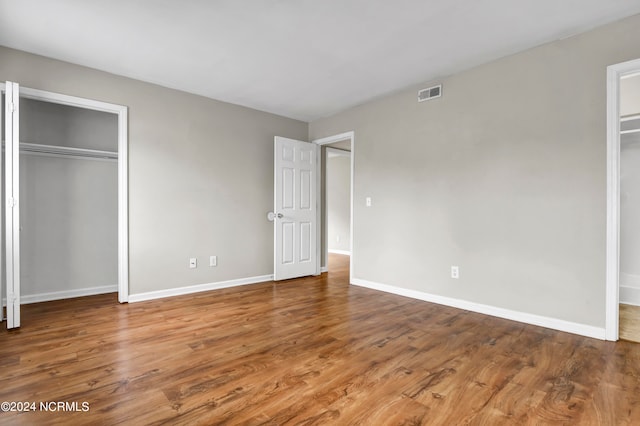 unfurnished bedroom with hardwood / wood-style flooring