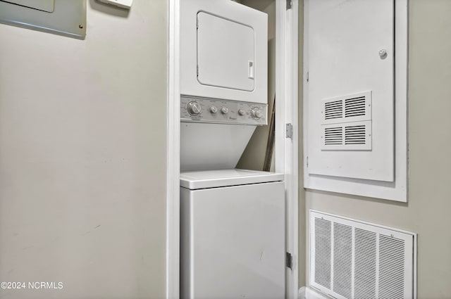 washroom featuring stacked washer and dryer