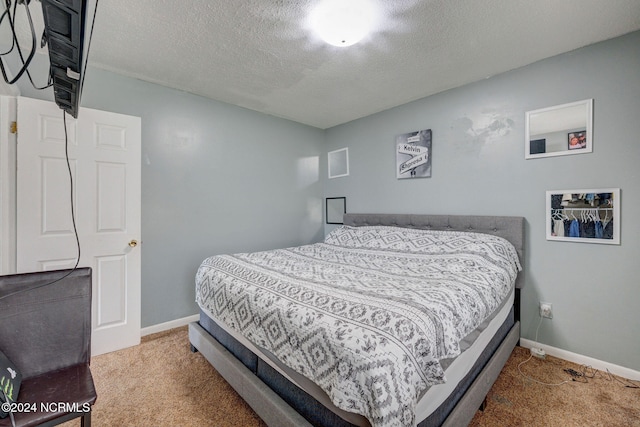 carpeted bedroom with a textured ceiling