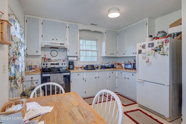 kitchen with stainless steel electric range and white fridge