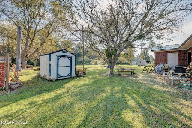 view of yard with a storage unit and central air condition unit