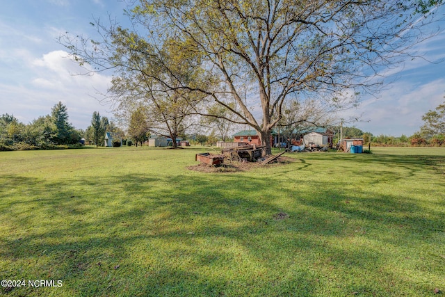 view of yard featuring a storage shed and a wooden deck