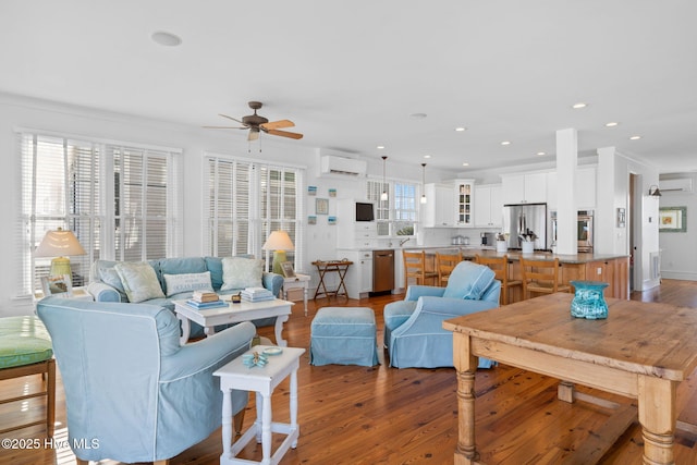 6615 W Beach Dr, Oak Island, NC 28465 - living area featuring a wall mounted air conditioner, ceiling fan, wood finished floors, and recessed lighting
