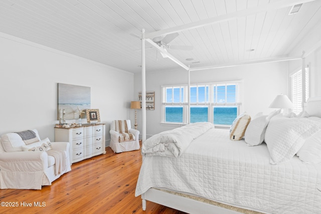 6615 W Beach Dr, Oak Island, NC 28465 - bedroom with wood ceiling, light wood finished floors, multiple windows, and a ceiling fan