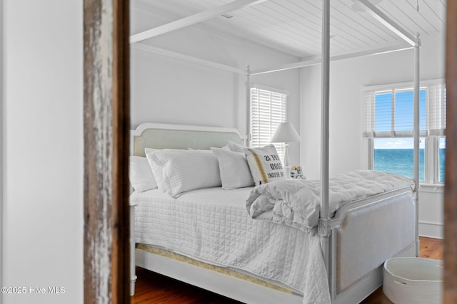 6615 W Beach Dr, Oak Island, NC 28465 - bedroom featuring multiple windows and wood finished floors