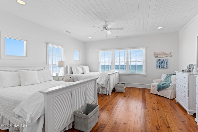 6615 W Beach Dr, Oak Island, NC 28465 - bedroom with wood ceiling, multiple windows, light wood-type flooring, ceiling fan, and recessed lighting