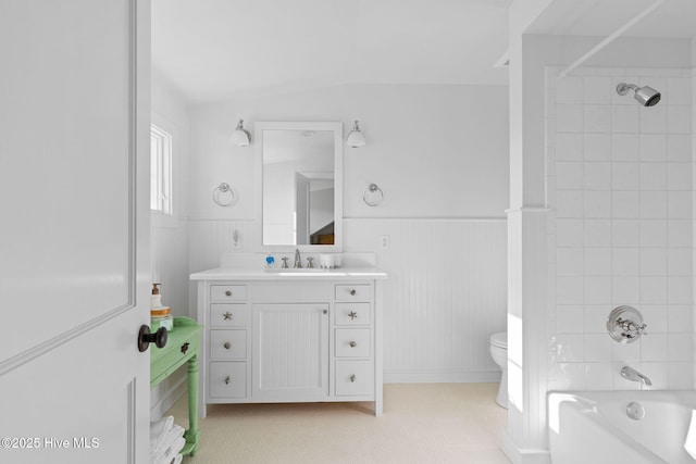 6615 W Beach Dr, Oak Island, NC 28465 - bathroom featuring toilet, shower / washtub combination, vanity, and wainscoting