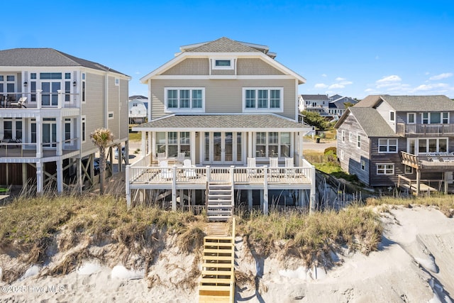 6615 W Beach Dr, Oak Island, NC 28465 - rear view of house with stairs, a shingled roof, and a deck