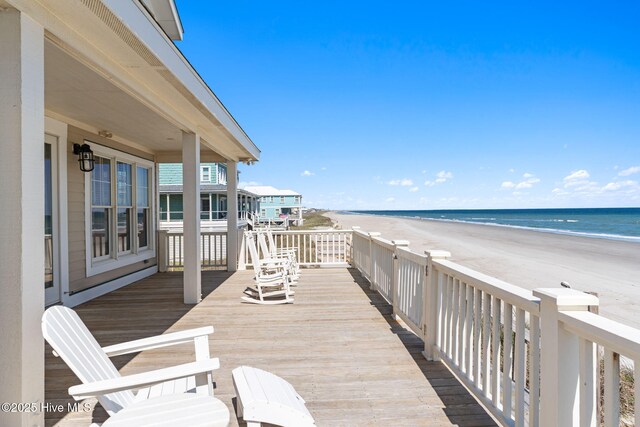 6615 W Beach Dr, Oak Island, NC 28465 - wooden deck with view of water and beach