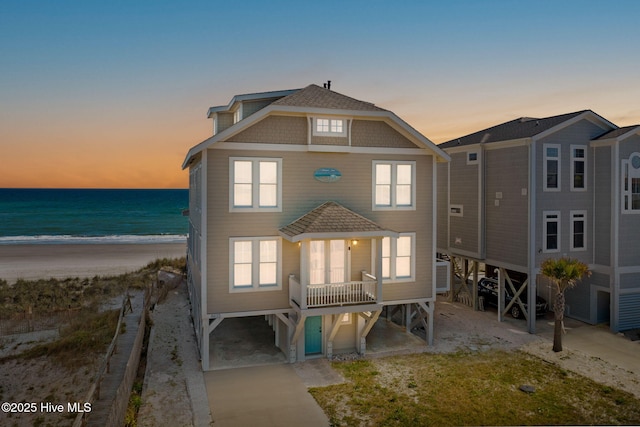 6615 W Beach Dr, Oak Island, NC 28465 - beach home featuring a carport, view of water and beach, and central AC