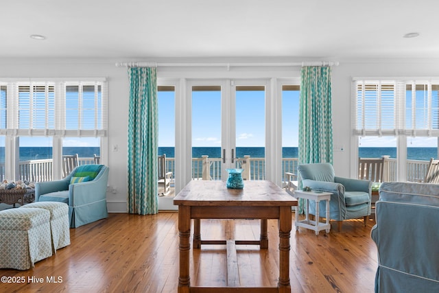 6615 W Beach Dr, Oak Island, NC 28465 - living area with wood-type flooring, healthy amount of natural light, and a water view