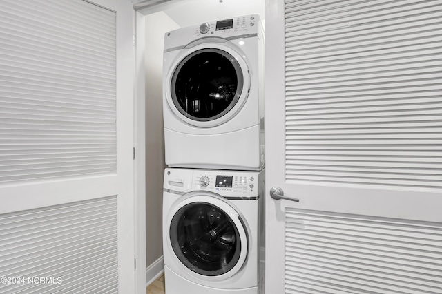 laundry room with stacked washer / dryer