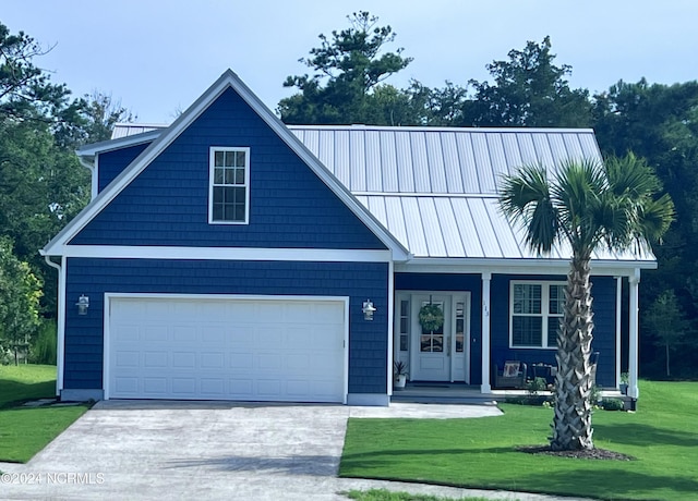 113 Evergreen Ln, Pine Knoll Shores, NC 28512 - view of front of house with a front lawn, driveway, and covered porch