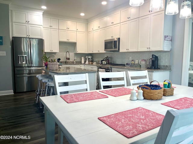 113 Evergreen Ln, Pine Knoll Shores, NC 28512 - kitchen featuring appliances with stainless steel finishes, white cabinetry, a sink, dark wood-style flooring, and recessed lighting