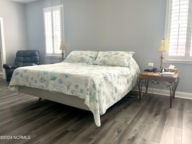 113 Evergreen Ln, Pine Knoll Shores, NC 28512 - bedroom with baseboards, multiple windows, and wood finished floors