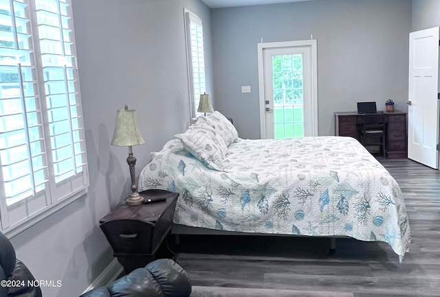 bedroom with dark hardwood / wood-style flooring and access to exterior