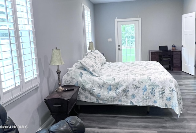 113 Evergreen Ln, Pine Knoll Shores, NC 28512 - bedroom featuring dark wood finished floors, access to exterior, and baseboards
