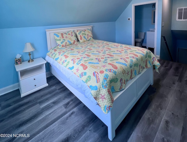 bedroom featuring lofted ceiling, dark hardwood / wood-style floors, and ensuite bathroom