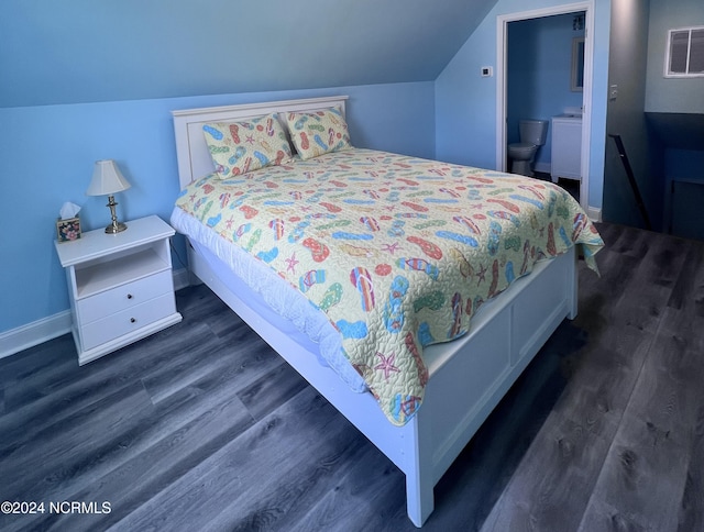113 Evergreen Ln, Pine Knoll Shores, NC 28512 - bedroom featuring lofted ceiling, dark wood-style floors, baseboards, and ensuite bath